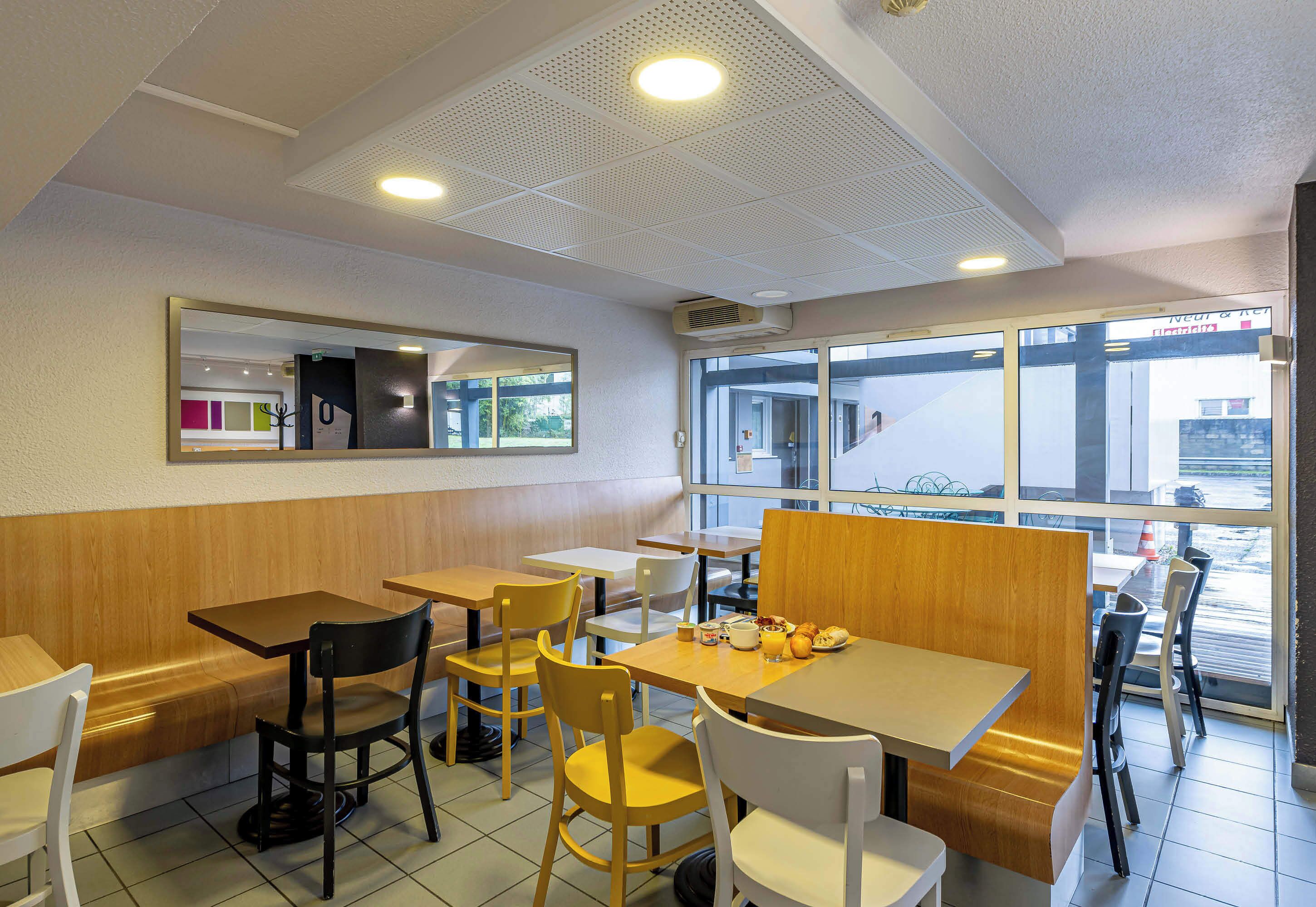 A restaurant interior with booths, tables, and chairs.