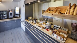 A breakfast bar with various food items and a coffee machine. - B&B HOTEL Beaune Sud (1) Palais des Congrès (Beaune)