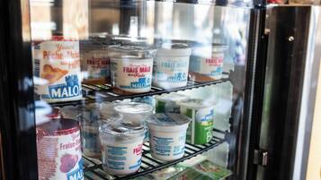 A refrigerated display case with various yogurt containers labeled 'Frais MALO' and 'MALO'.