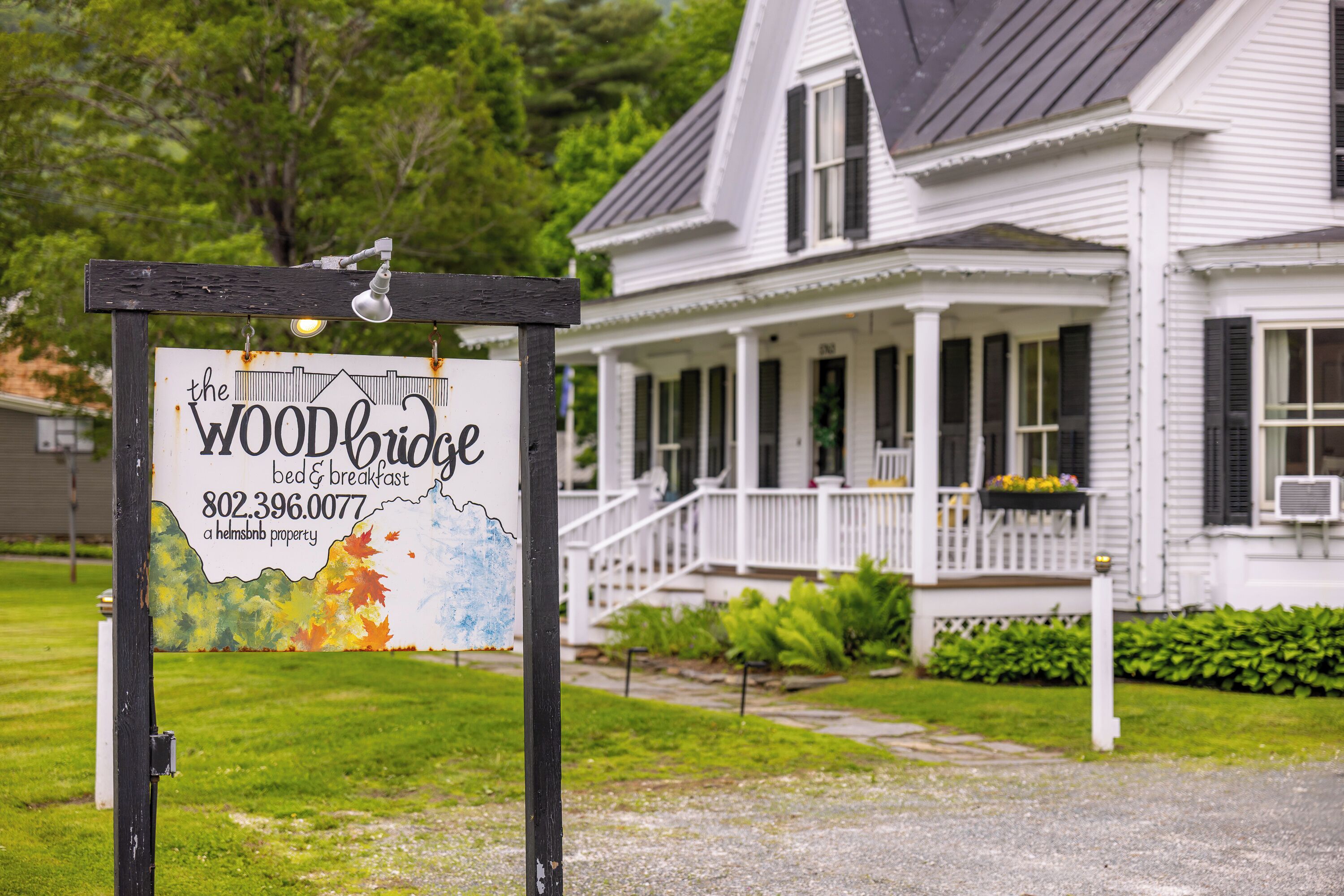 A sign for The Woodbridge bed & breakfast with a contact number.