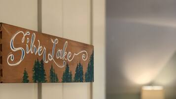 A wooden sign with the text "SilverLake" and a forest scene.
