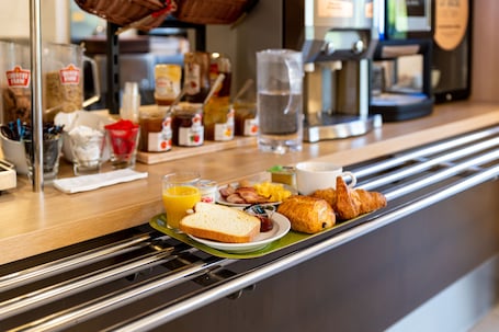 A breakfast buffet with various food items and beverages.