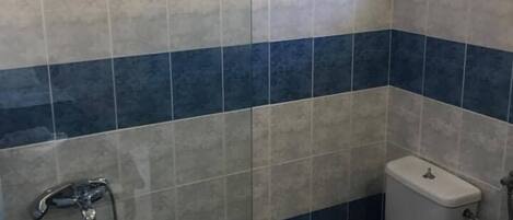 Un baño con inodoro, bidé y bañera.