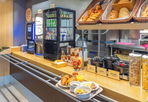 A breakfast buffet with croissants, bread, and various breakfast items.