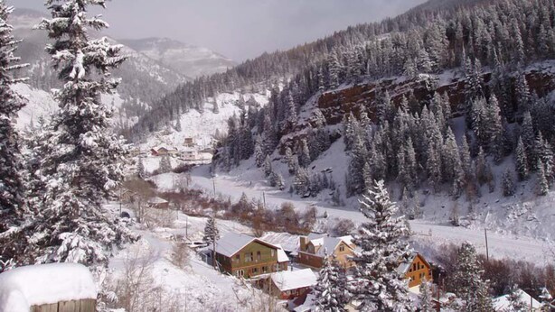 A snow-covered mountain village with houses and trees. - The Green Bridge Inn (Red Cliff)