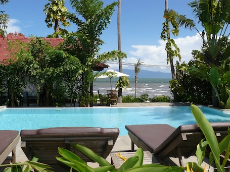 Outdoor pool, an infinity pool, pool umbrellas, sun loungers