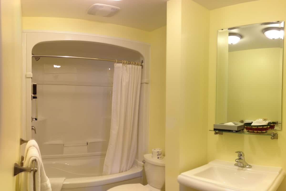 Une salle de bain avec une baignoire, des toilettes et un lavabo.