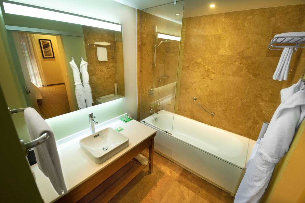 suite | bathroom | designer toiletries, hair dryer, bathrobes, slippers