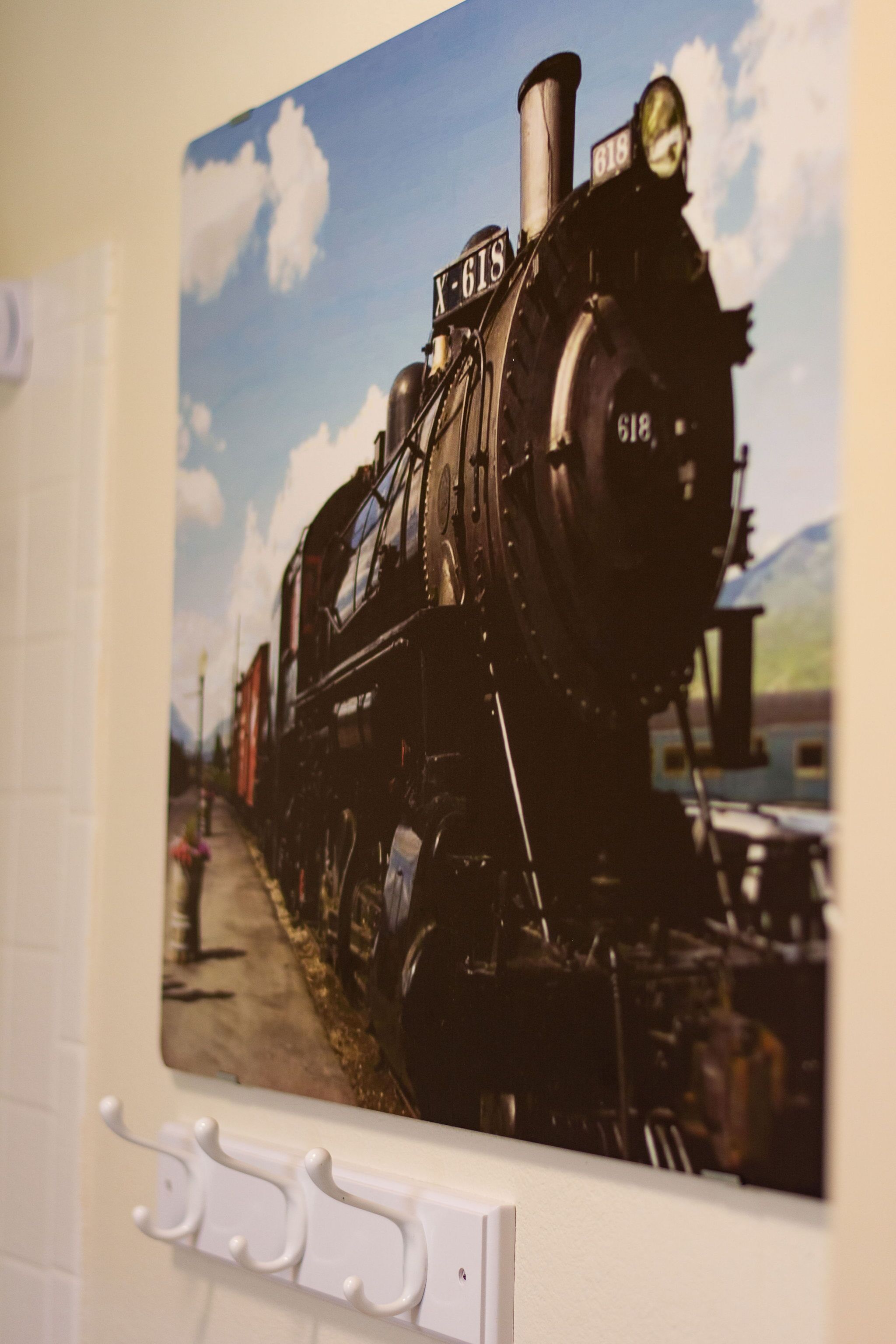 A black steam locomotive with the number 618 on a track.