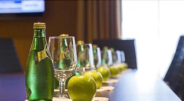 A row of green bottles and glasses on a bar counter. - Hampton Inn by Hilton Ottawa Airport, ON, CN (Ottawa)