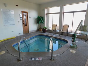 An indoor pool area with a sign indicating a 30 ft depth limit.