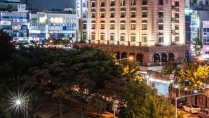 A multi-story hotel with a prominent entrance and signage. - Hotel Aura (Ansan)