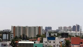 A cityscape with multi-story residential buildings, some with balconies, and a variety of building heights and designs.