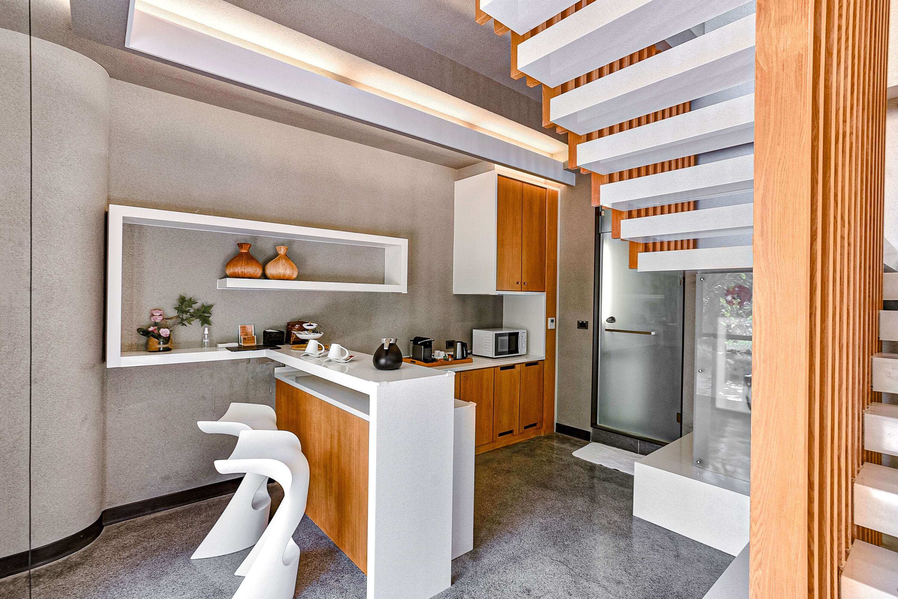 A modern kitchen with white cabinetry, a built-in microwave, and a glass door refrigerator.