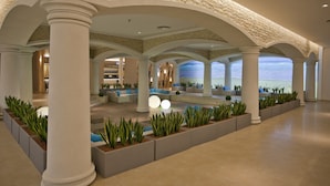 A spacious lobby with a pool, columns, and seating areas. - DIT Evrika Beach Club Hotel (Nessebar)