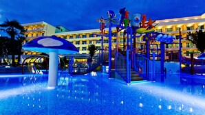 A water park area with a large umbrella structure, slides, and a pool. - DIT Evrika Beach Club Hotel (Nessebar)