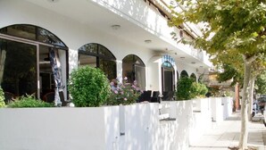 A hotel with a white facade, large windows, and a sign indicating it is a hotel. - Aegeon Hotel (Kos)