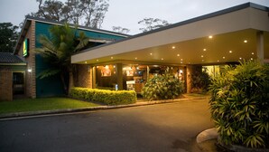 A modern hotel with a covered entrance, well-maintained landscaping, and a brick facade. - The Select Inn Gosford (Wyoming)