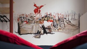 Un mural con figuras abstractas y una escalera.