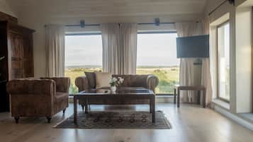 Luxury Suite, Balcony | Living area | 32-inch flat-screen TV with cable channels, TV