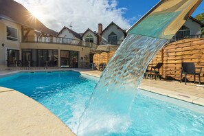 Seasonal outdoor pool, open 9:00 AM to 8:00 PM, pool umbrellas