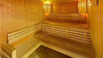A sauna with wooden benches and benches, a tiled floor, and wooden walls.
