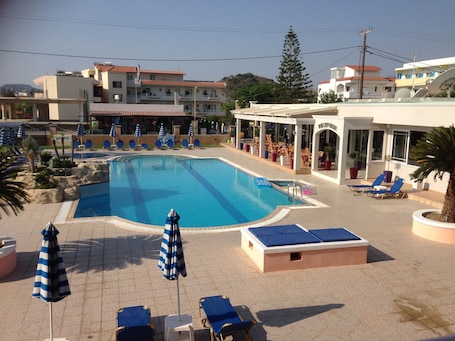 Outdoor pool, a waterfall pool, open 8 AM to 8 PM, pool umbrellas. Rhodian Rose Hotel