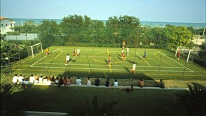 A soccer field with players and spectators. - Residence Azzurro (Massignano)