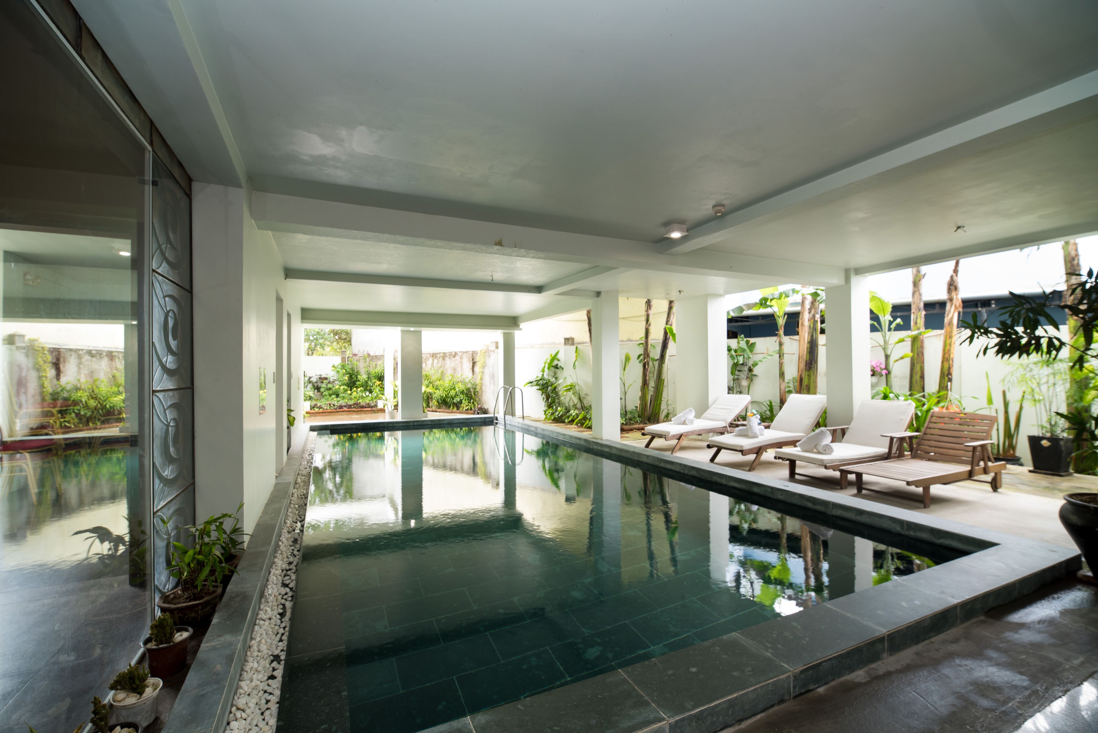 Indoor pool, pool umbrellas, sun loungers