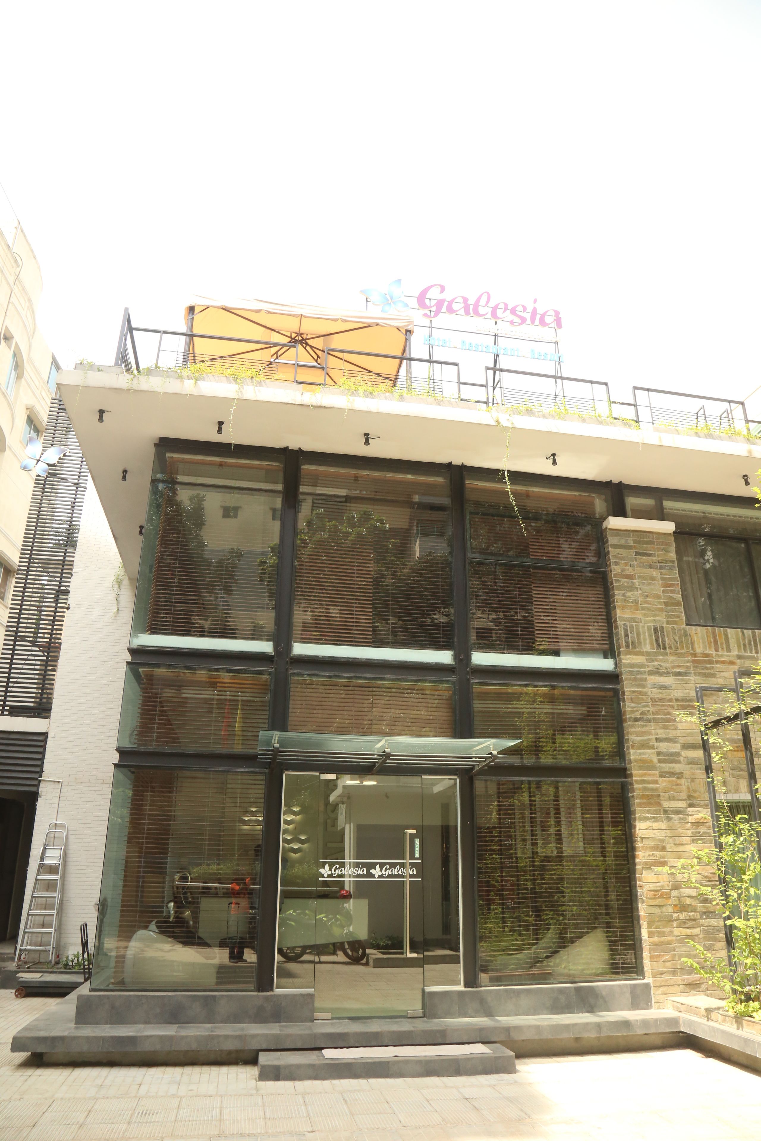 A modern building with a glass facade, a visible entrance, and a sign reading "Galicia".