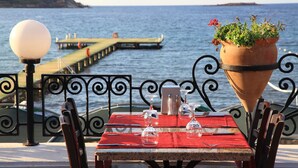A table set for dining with a view of the sea and a pier in the background. - Cactus Fleur Bay Resort - All inclusive (Bodrum)
