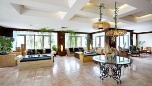 A spacious lobby with high ceilings, large windows, and a variety of seating arrangements including sofas and chairs. - Cactus Fleur Bay Resort - All inclusive (Bodrum)
