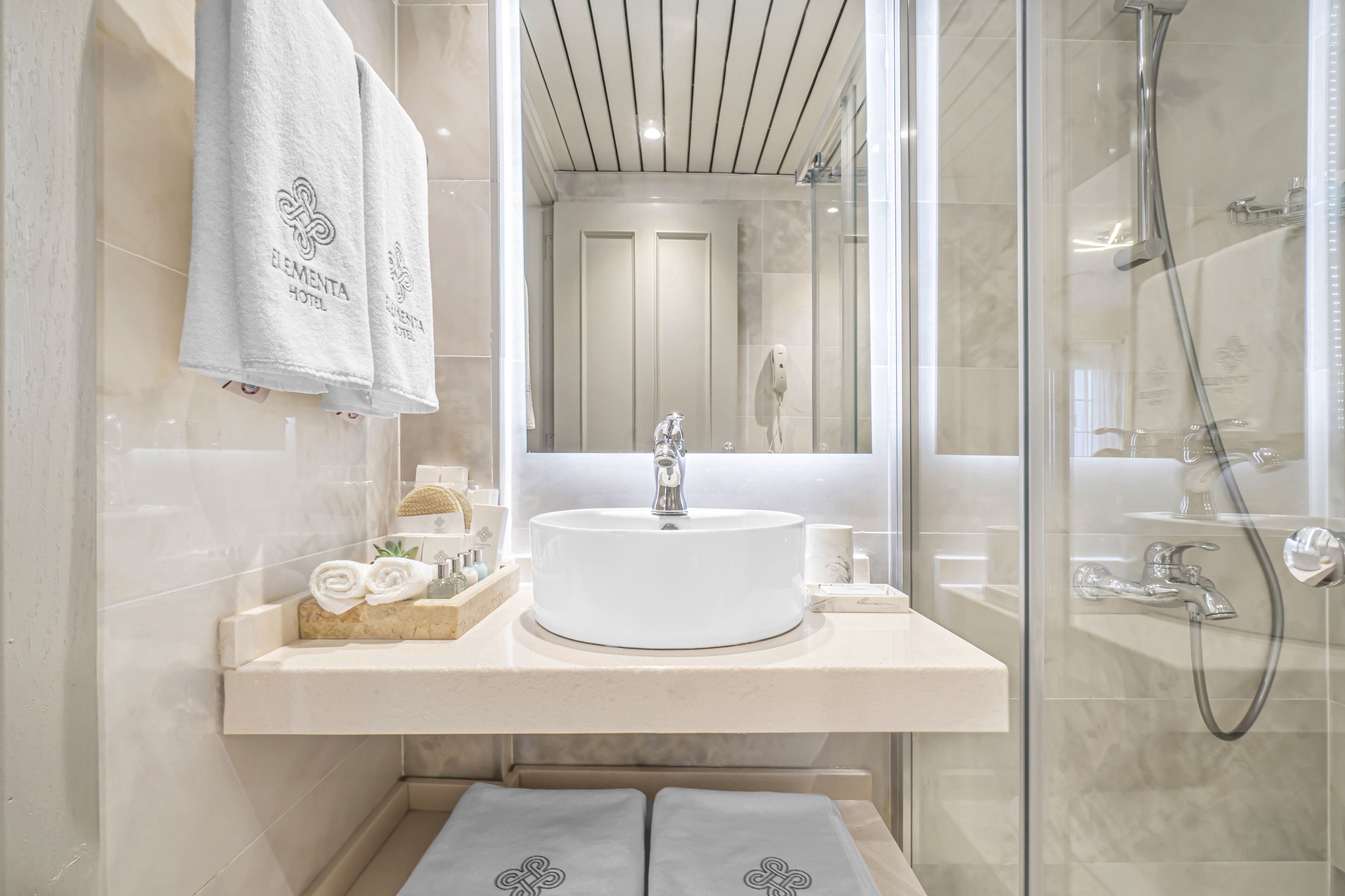 shower, hair dryer, slippers, towels