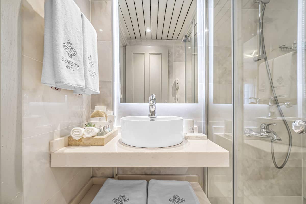 shower, hair dryer, slippers, towels