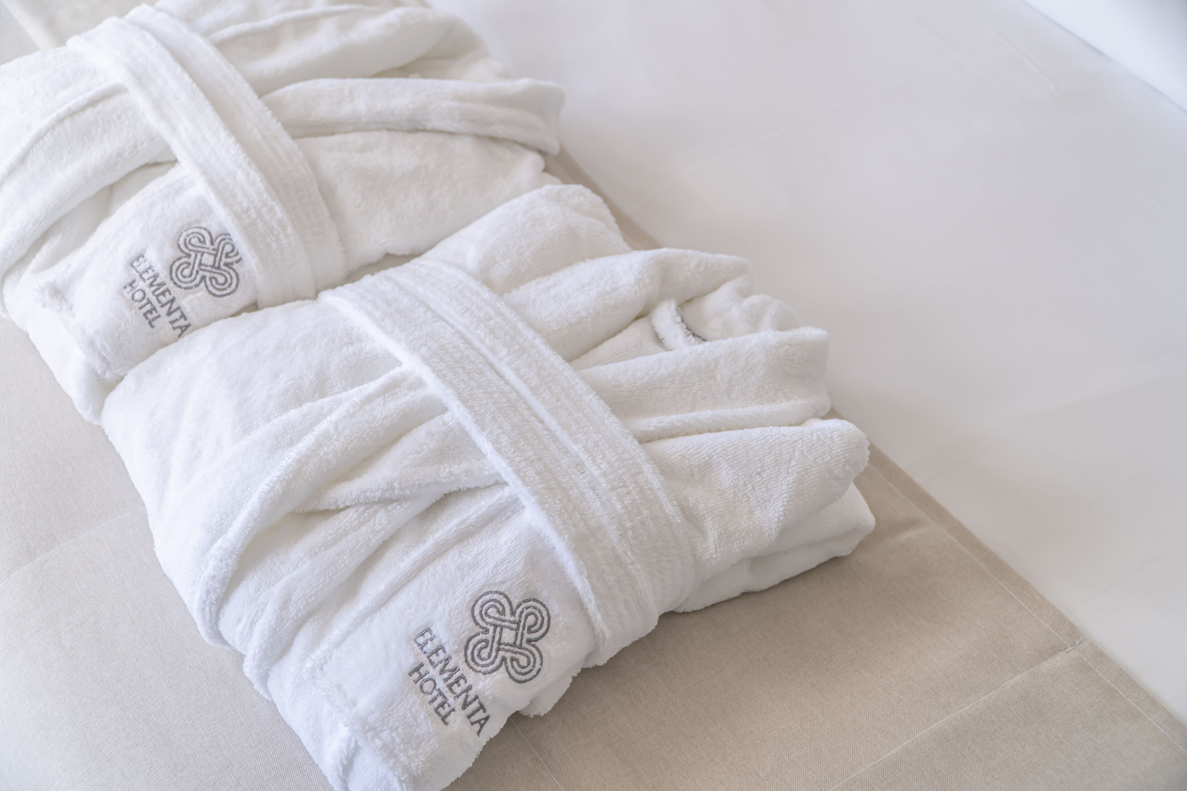 shower, hair dryer, slippers, towels