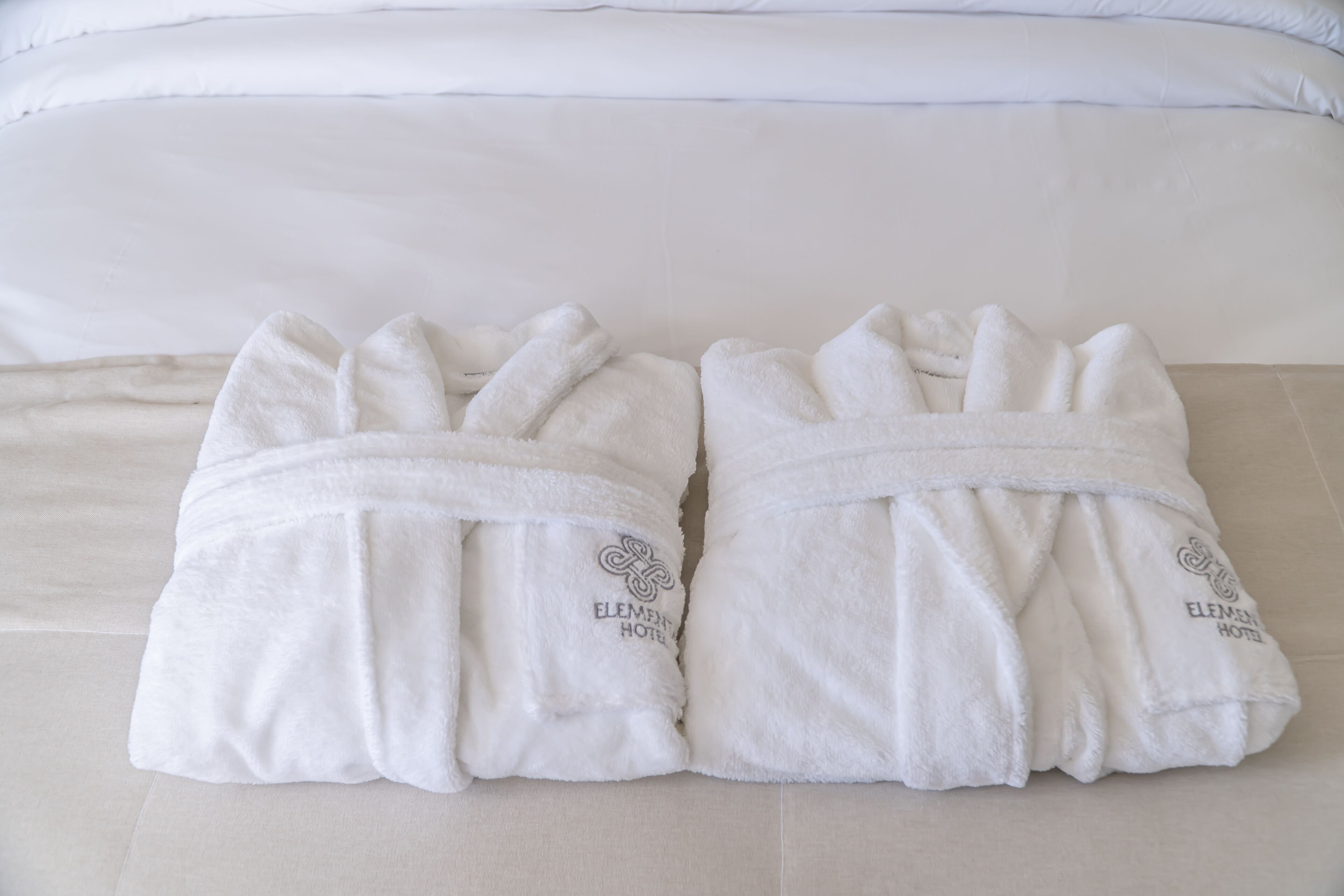 shower, hair dryer, slippers, towels