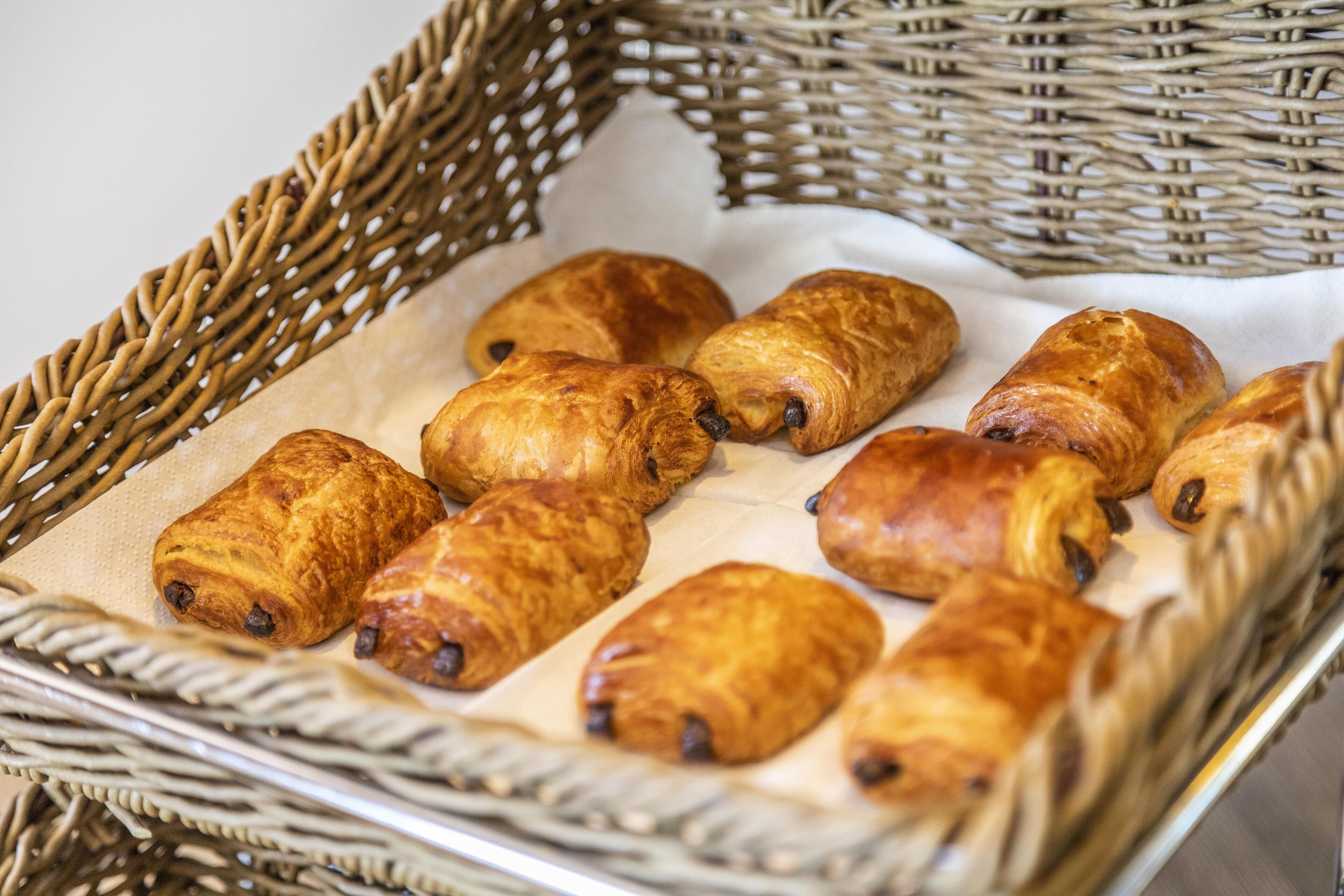 A basket of golden-brown pastries on a white cloth.