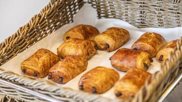 A basket of golden-brown pastries on a white cloth.