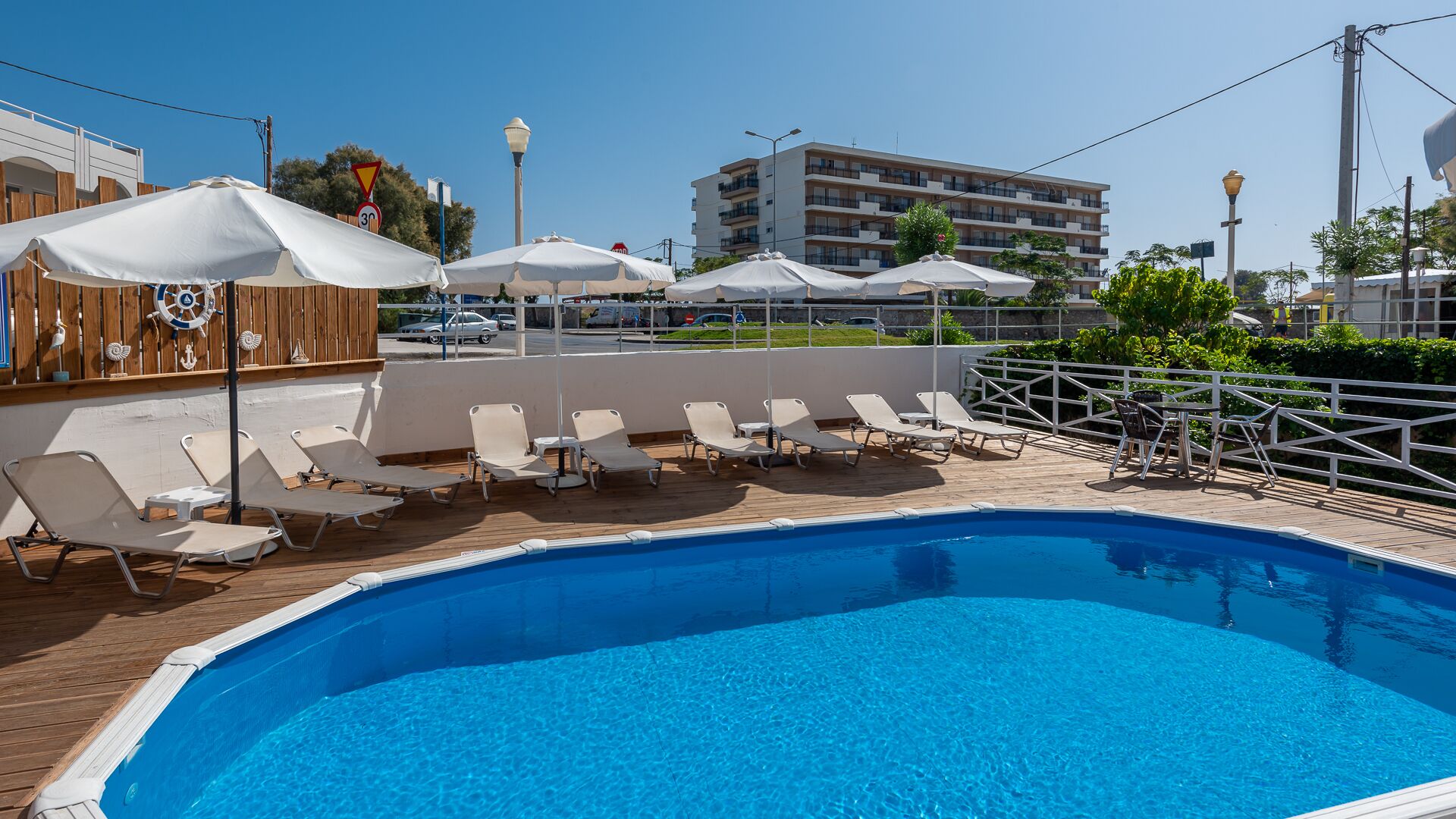 seasonal outdoor pool, pool umbrellas, pool loungers