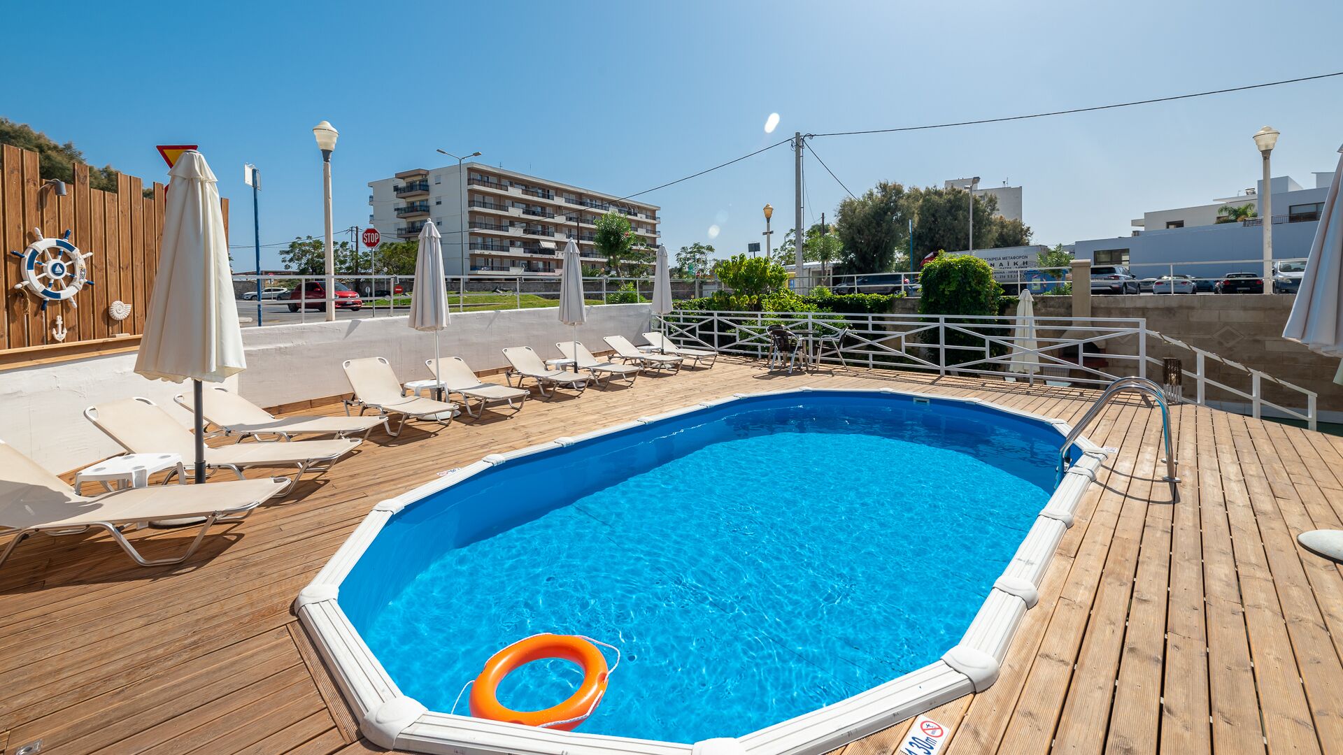 seasonal outdoor pool, pool umbrellas, pool loungers