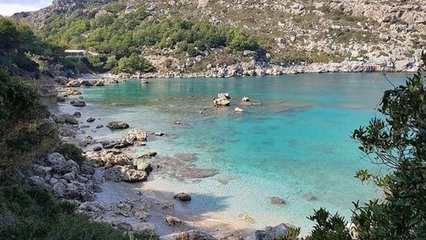 A coastal landscape with clear turquoise waters, rocky shores, and greenery. - Ladiko Suites Faliraki  (Rhodes)