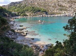 A coastal landscape with clear turquoise waters, rocky shores, and greenery. - Ladiko Suites Faliraki  (Rhodes)