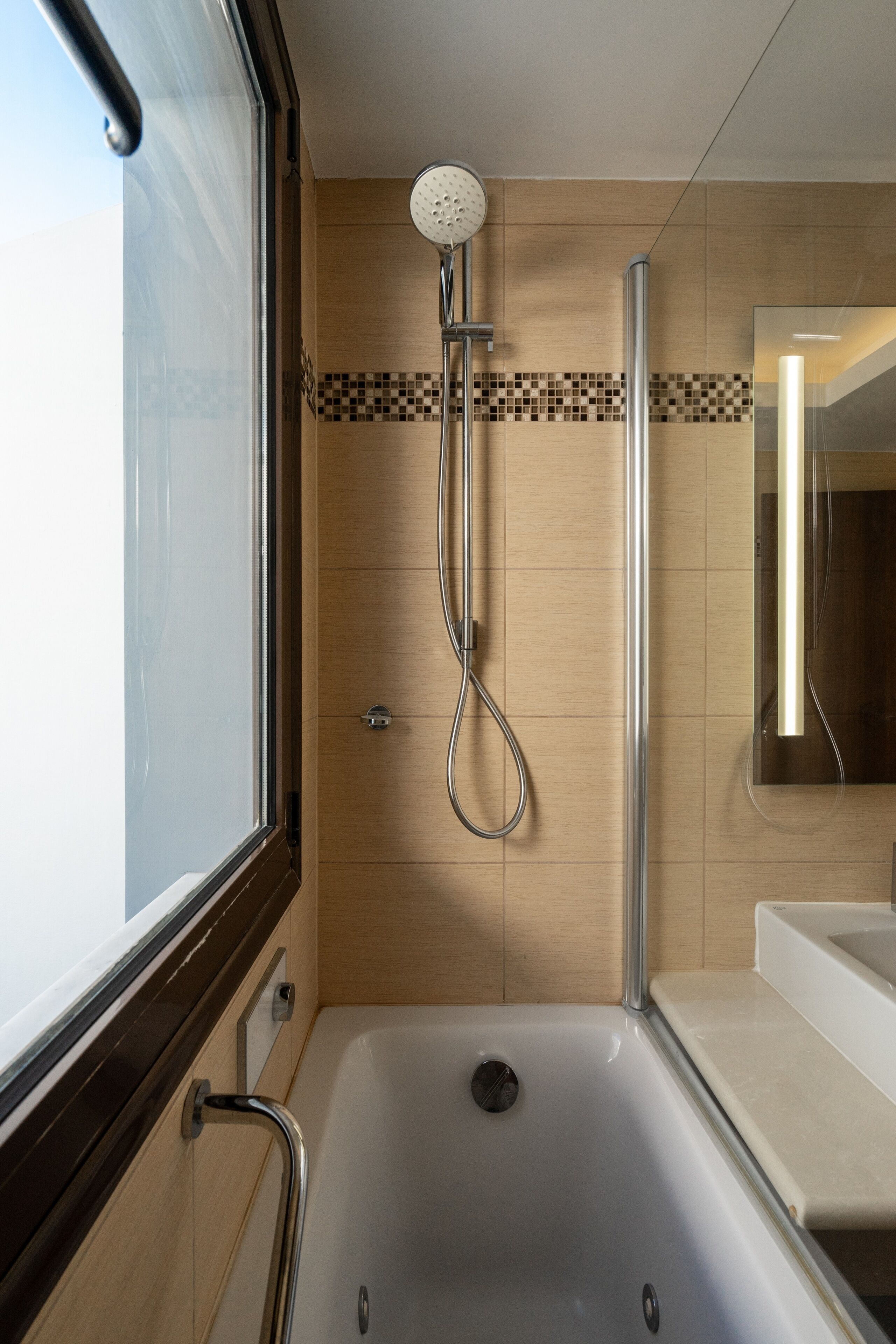 deluxe suite | bathroom | rainfall showerhead, hair dryer, towels, soap