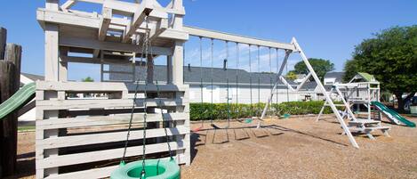 A playground with a swing set, tire swing, and climbing structure.