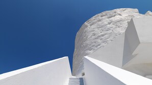 A white staircase leading up to a building with a clear blue sky in the background. - The Windmill Kimolos (Kimolos)