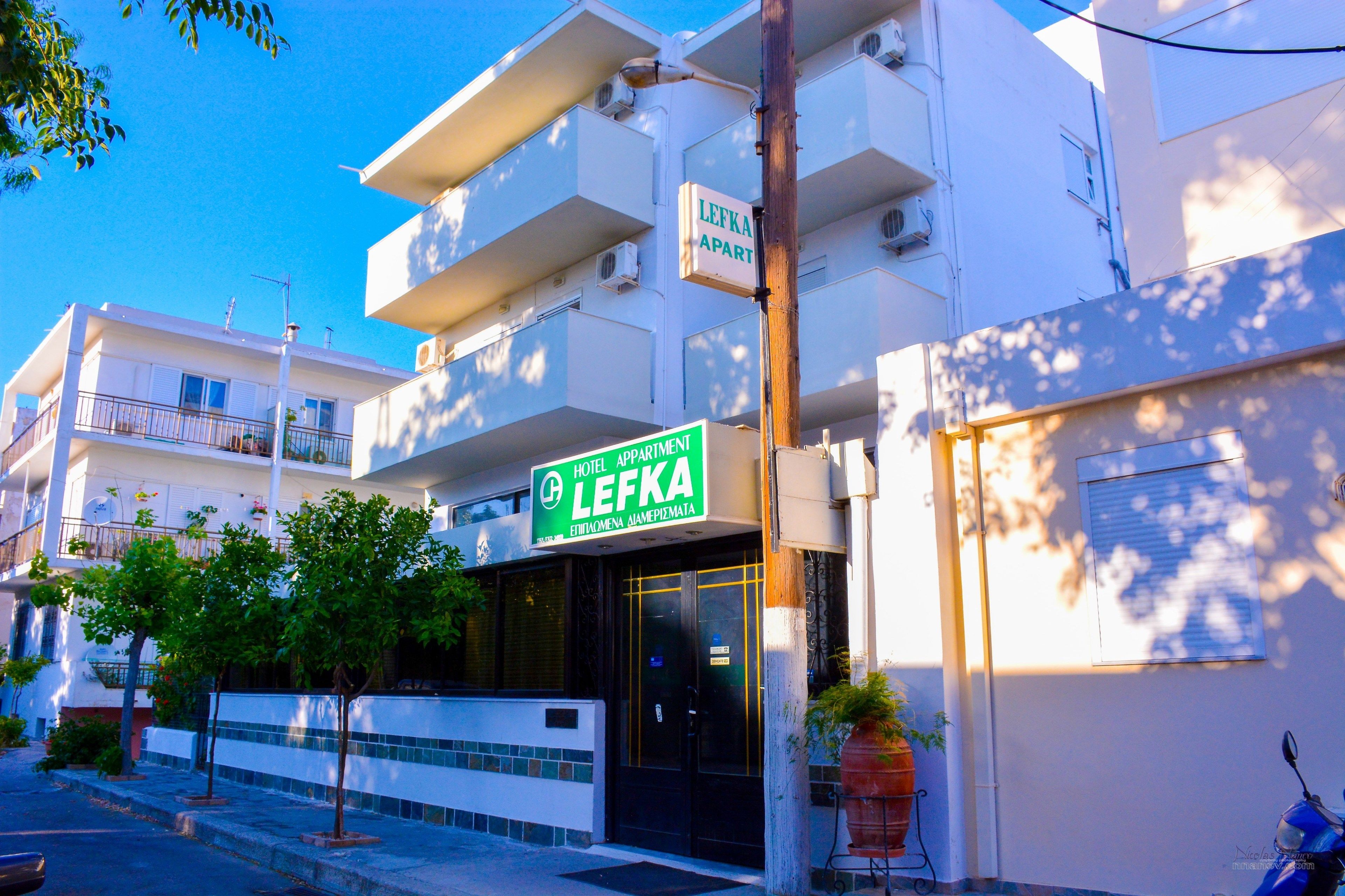 A hotel named Lefka with a sign indicating it is an apartment hotel.