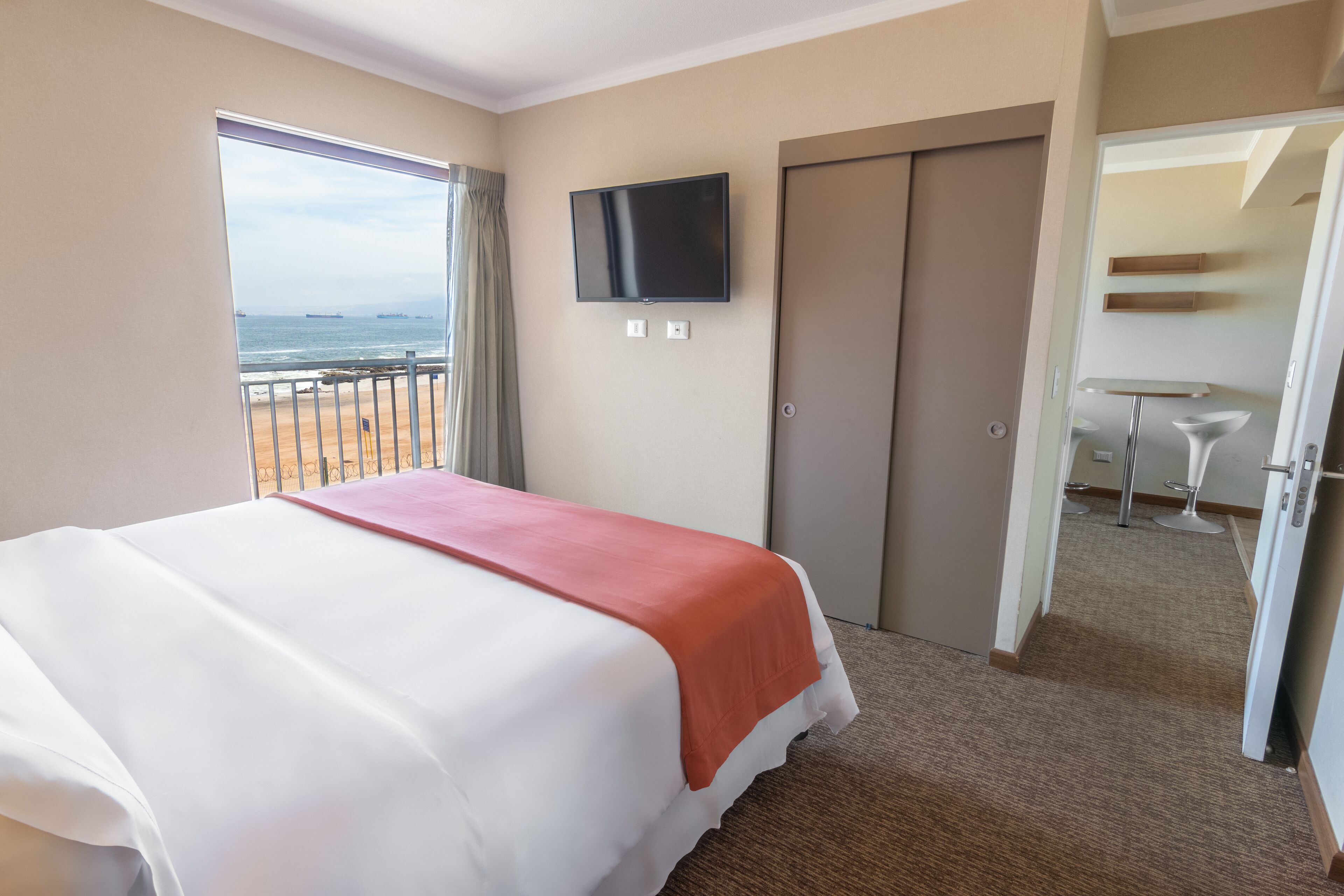 junior suite, 1 king bed, balcony, beach view | minibar, in-room safe, desk, laptop workspace