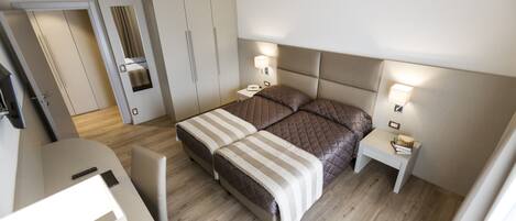 Un dormitorio moderno con cama, mesitas de noche y armario.