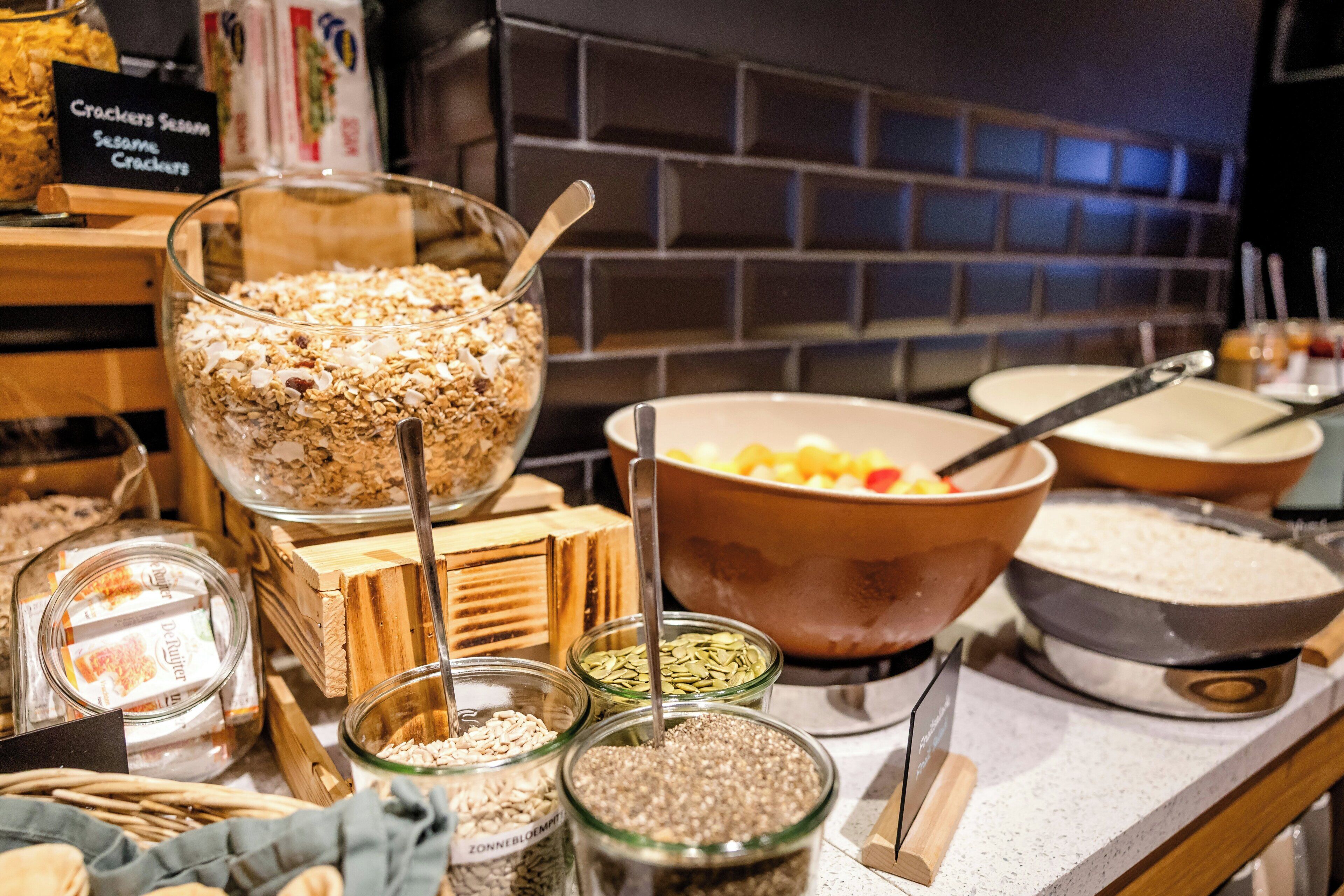 A buffet setup with various food items and utensils.