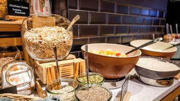 A buffet setup with various food items and utensils.